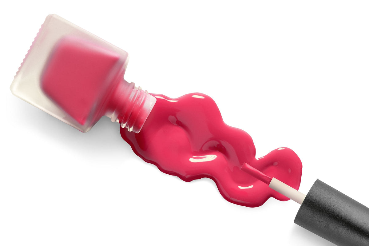 A bottle of nail polish with its brush on a white background