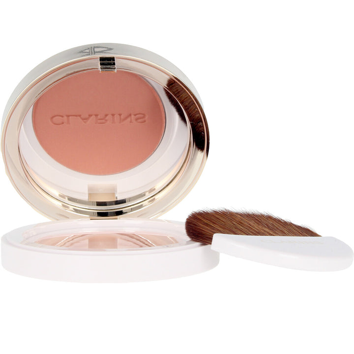 Compact pressed powder blush in warm coral shade, 5 g pan, smooth textured surface