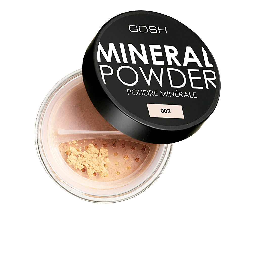 Jar of ivory mineral loose powder with fine, matte texture, brush suggested