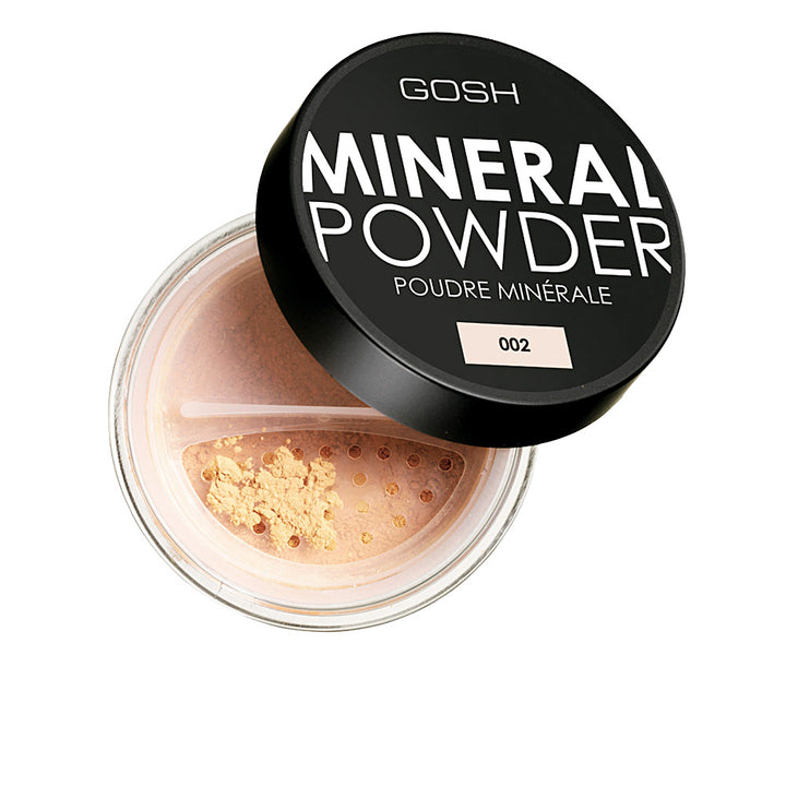 Jar of ivory mineral loose powder with fine, matte texture, brush suggested