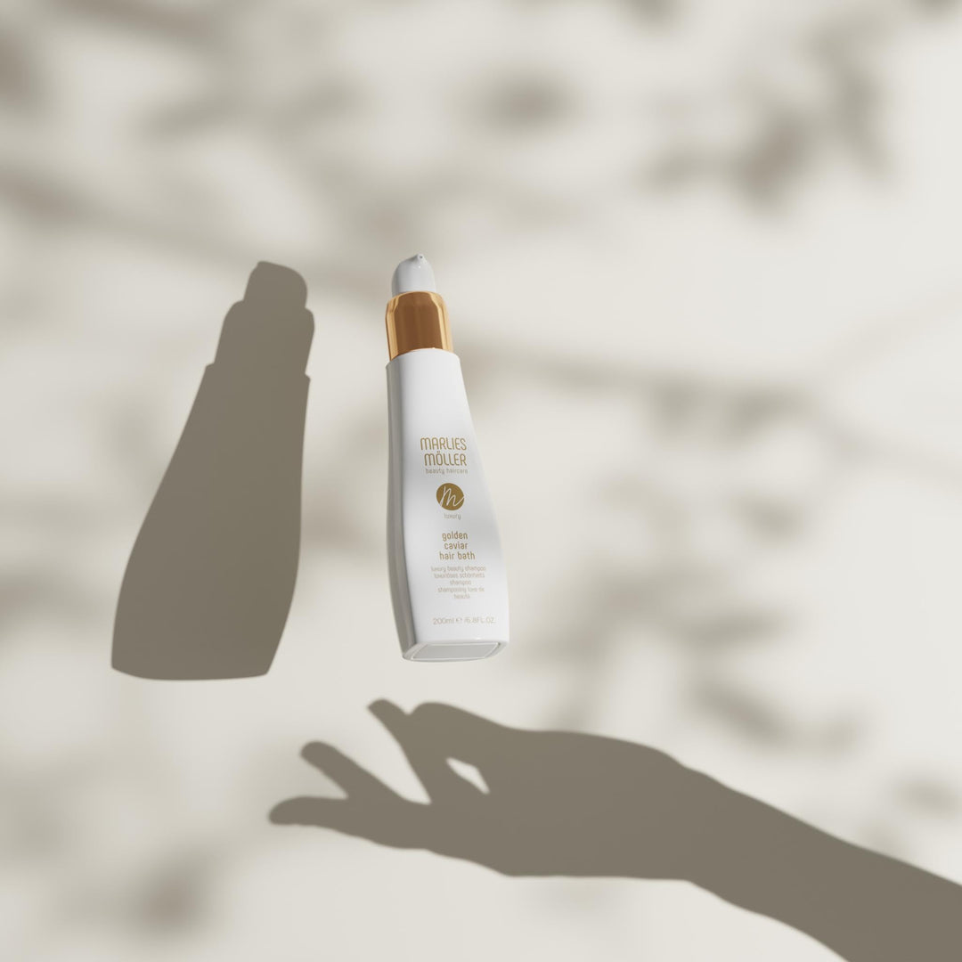 200 ml pump bottle of Golden Caviar Repair Hair Bath, amber-hued shampoo