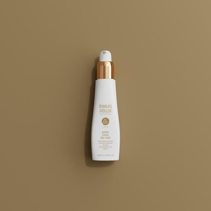 200 ml pump bottle of Golden Caviar Repair Hair Bath, amber-hued shampoo