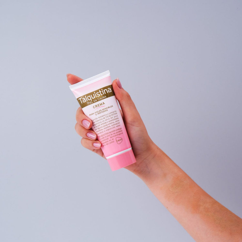 Tube of Talquistina Calamine Cream beside soothing pink calamine powder