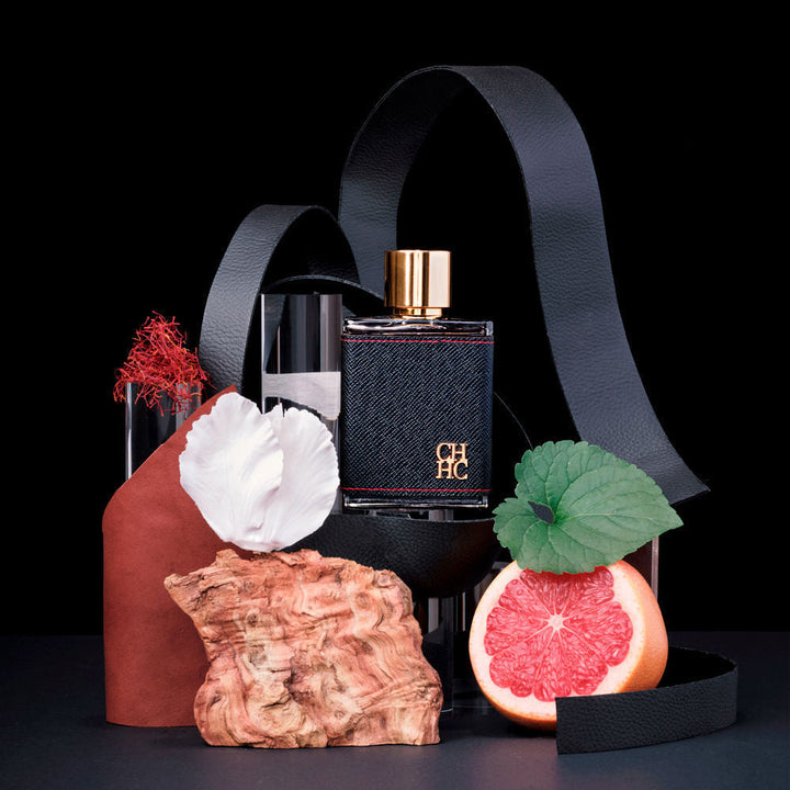 Clear glass 100 ml perfume bottle with silver cap; spiced oriental fragrance details