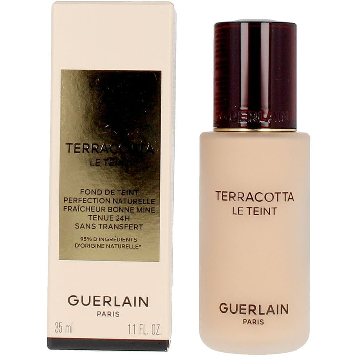 Frosted glass foundation bottle with dark brown embossed cap and gold-label rectangular box, Guerlain