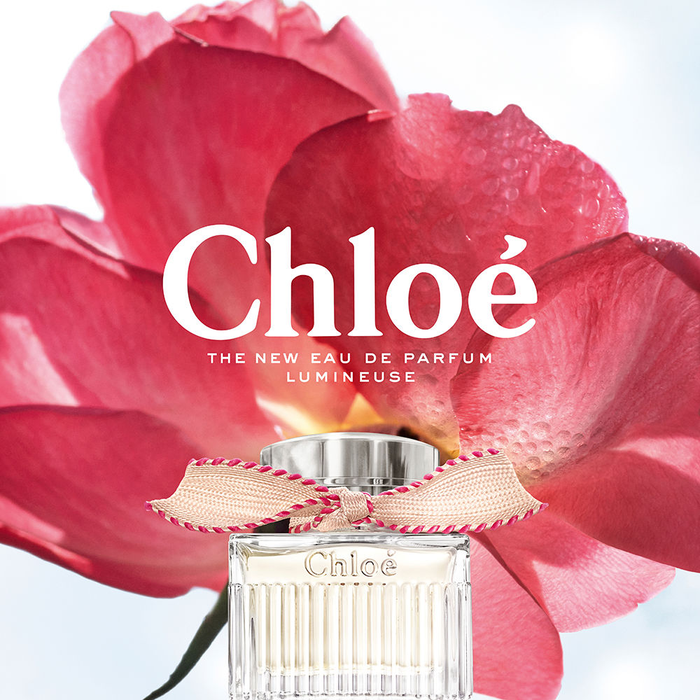 50 ml clear glass perfume bottle with beige ribbon and silver cap, floral scent