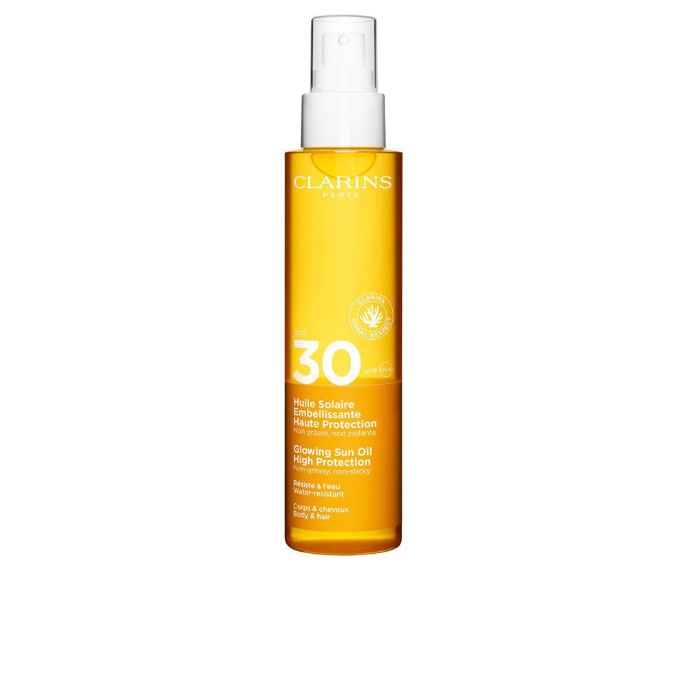 Clarins solar body oil mist SPF 30 bottle with sunlit backdrop