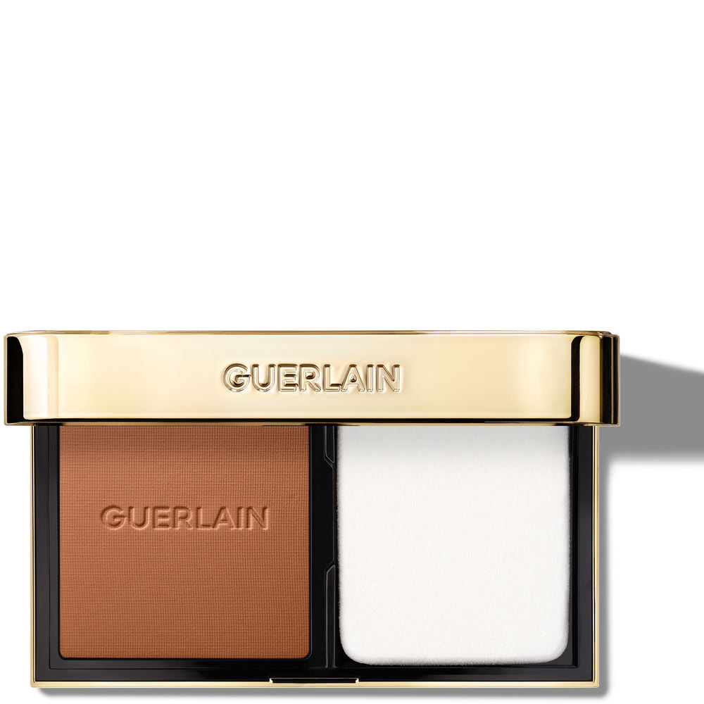 Compact powder foundation with gold‑flecked pressed powder, included sponge applicator, 10 g