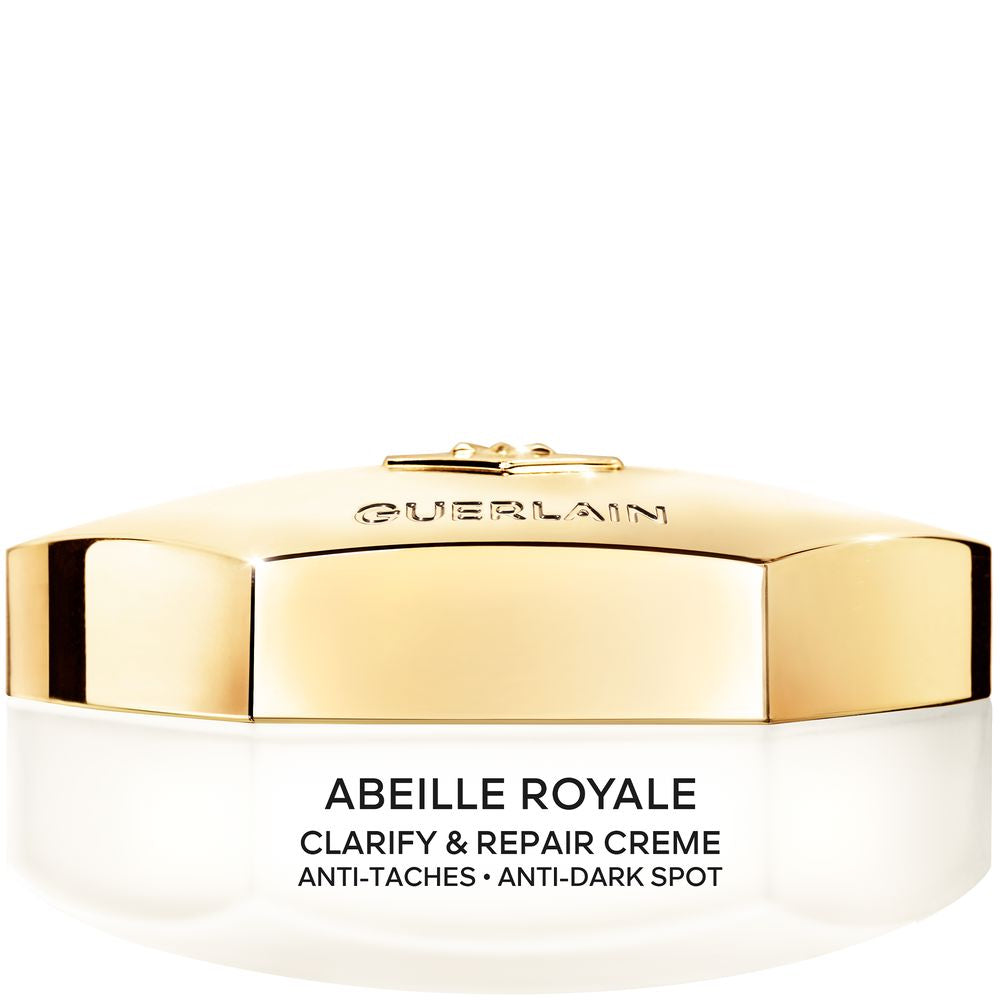 Tarro de crema lujosa Guerlain con enfoque en miel y vitamina C sobre fondo neutro