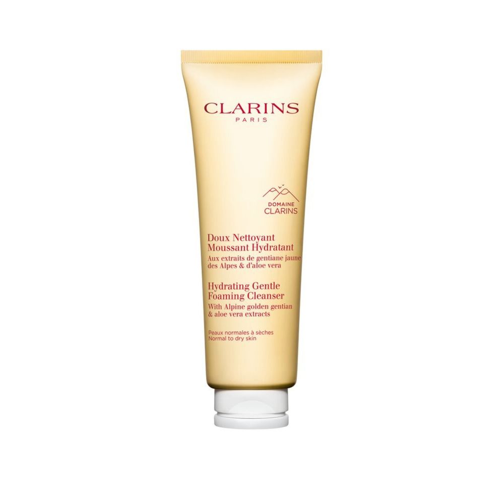 Minimalist light yellow plastic cleanser tube with flip-top cap and subtle botanical label, Clarins