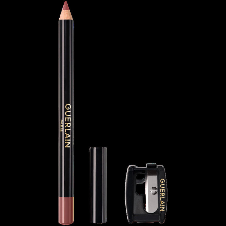 Guerlain lip liner pencil in black with pinkish-nude tip, wood and plastic body, gold text branding.