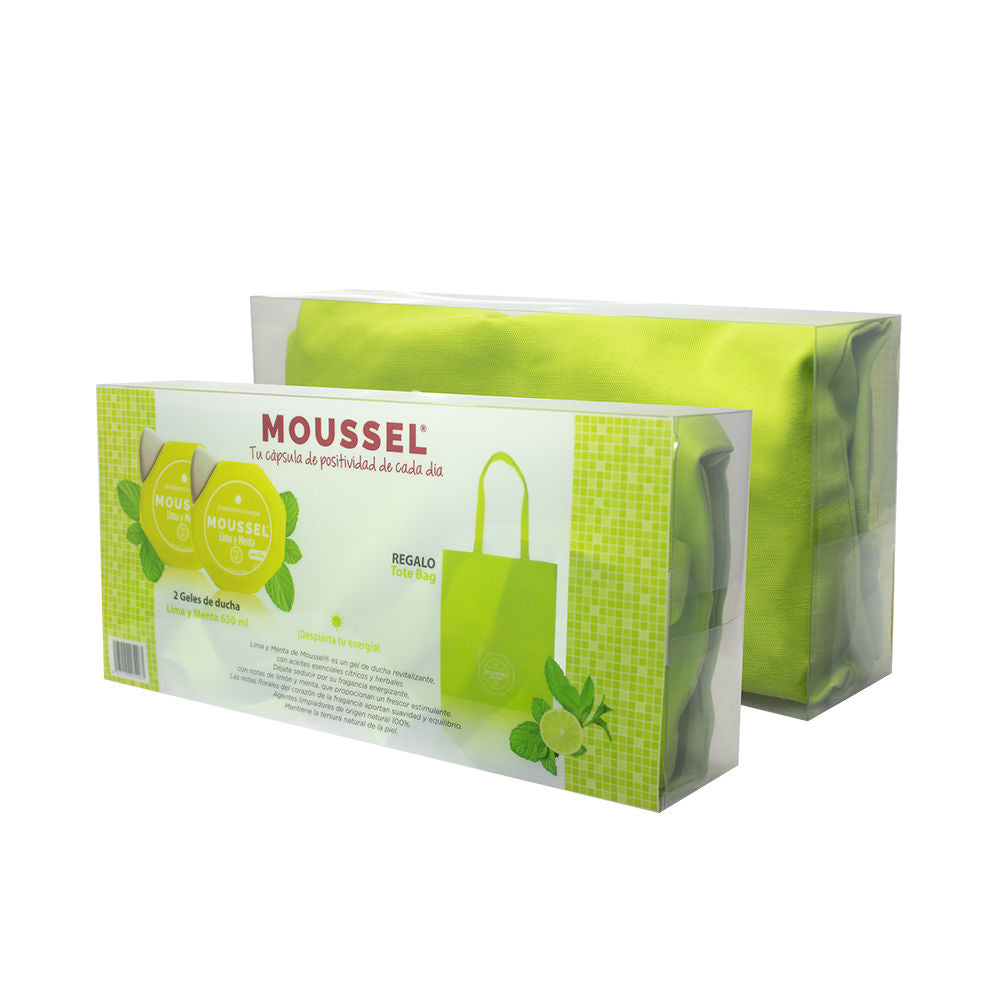 Bottle of Moussel citrus and mint shower cream beside mint leaves and a sliced citrus
