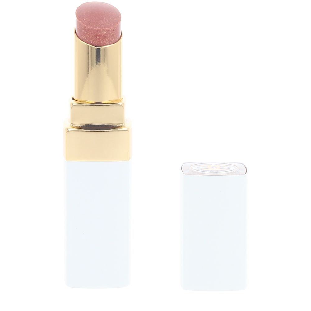 Small shea‑infused tinted lip balm in honey shade, clear cap, 3 g