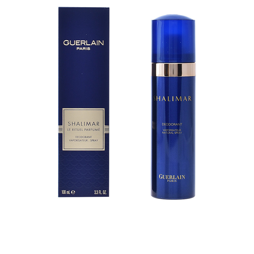 Blue plastic deodorant spray with metallic band and box packaging, refined luxury styling by Guerlain.