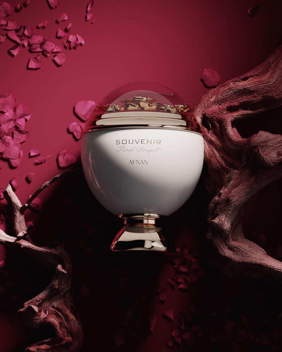 White dome perfume bottle with gold decorative base and floral detail under transparent top, Afnan.