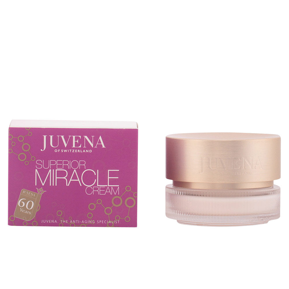 Juvena Glass jar with gold lid inside purple, gold, beige cardboard box, molecular pattern detailing