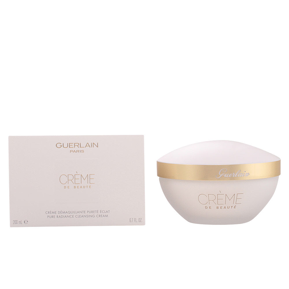 White cleansing cream in round plastic jar with gold lid beside cardboard box, Guerlain branding visible