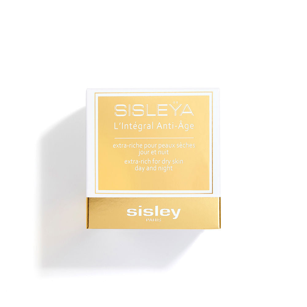 Sisley Frosted glass face cream jar with gold lid band beside square white and gold box, printed text visible