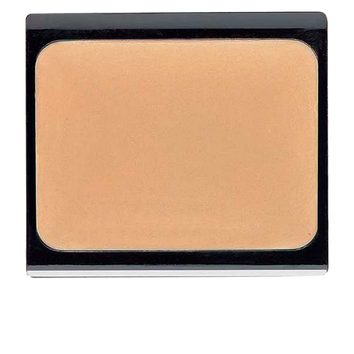 Small 4.5 g compact cream concealer in beige‑apricot shade, sleek pot packaging