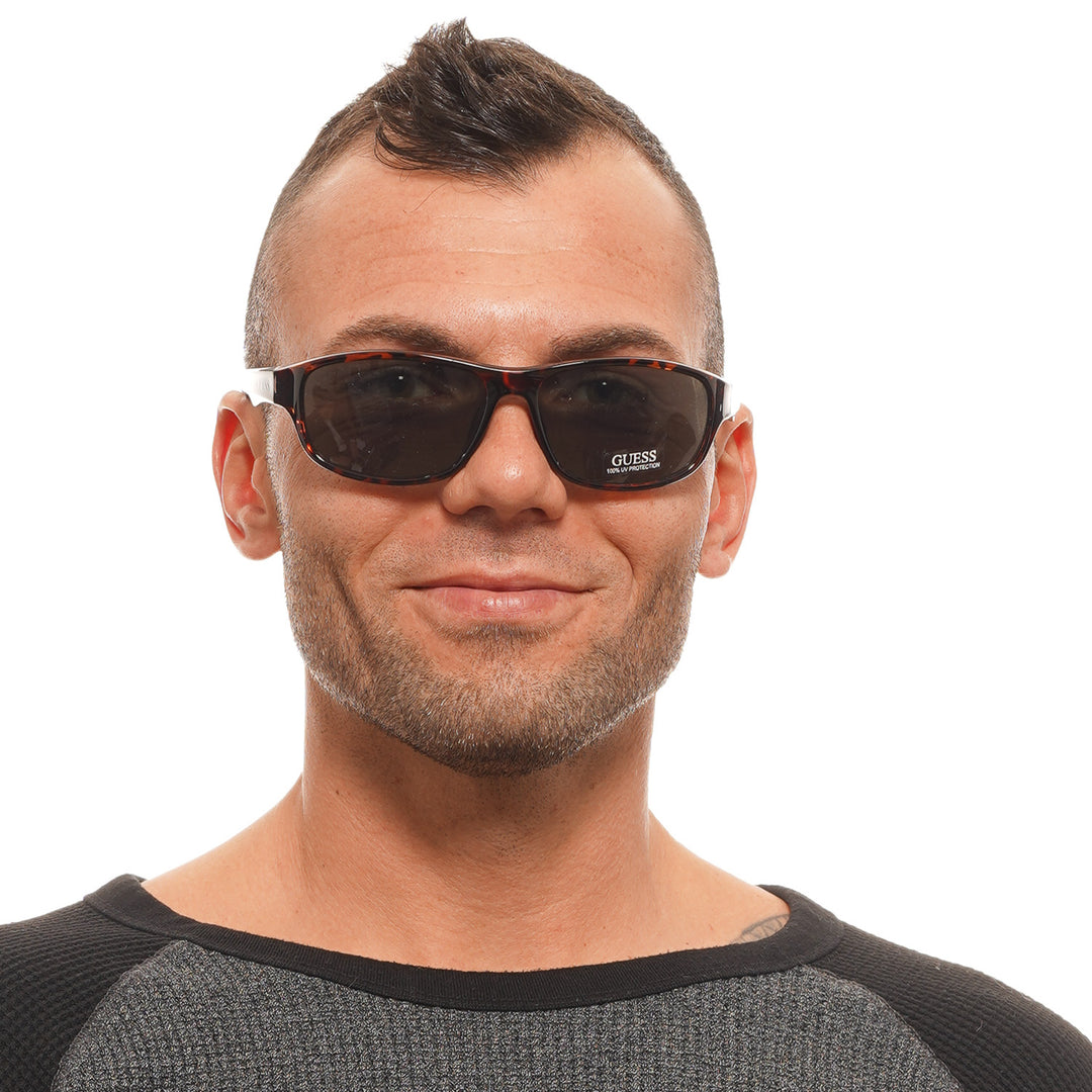 Unisex tortoise shell rectangular sunglasses in plastic full-rim with dark green lenses and logo on temple
