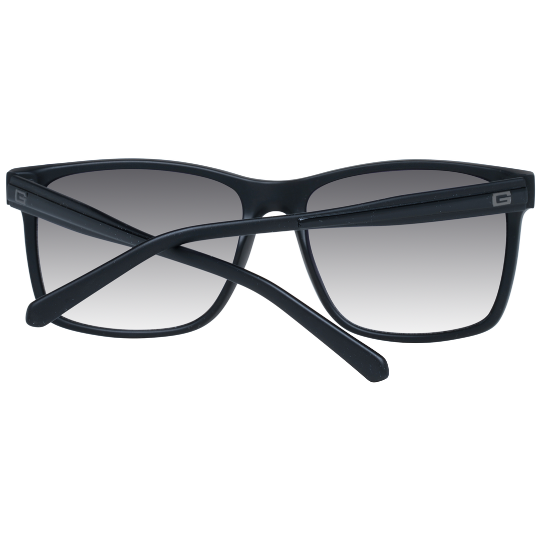 Black rectangular sunglasses on neutral background with gradient lenses and visible logo on temple