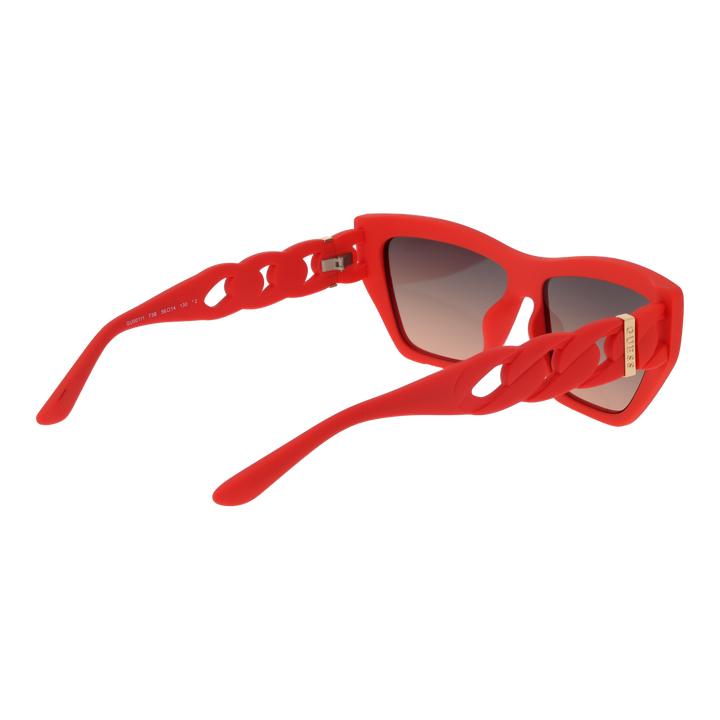 Red cat-eye sunglasses in glossy plastic with gradient lenses and gold chain-link temples, angled three-quarter view