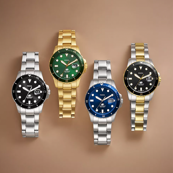 Gold-tone diver watch with green dial, rotating bezel, luminous markers, and metal bracelet
