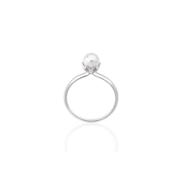 Thin silver band ring featuring a single white cultured pearl in a prong setting on neutral background