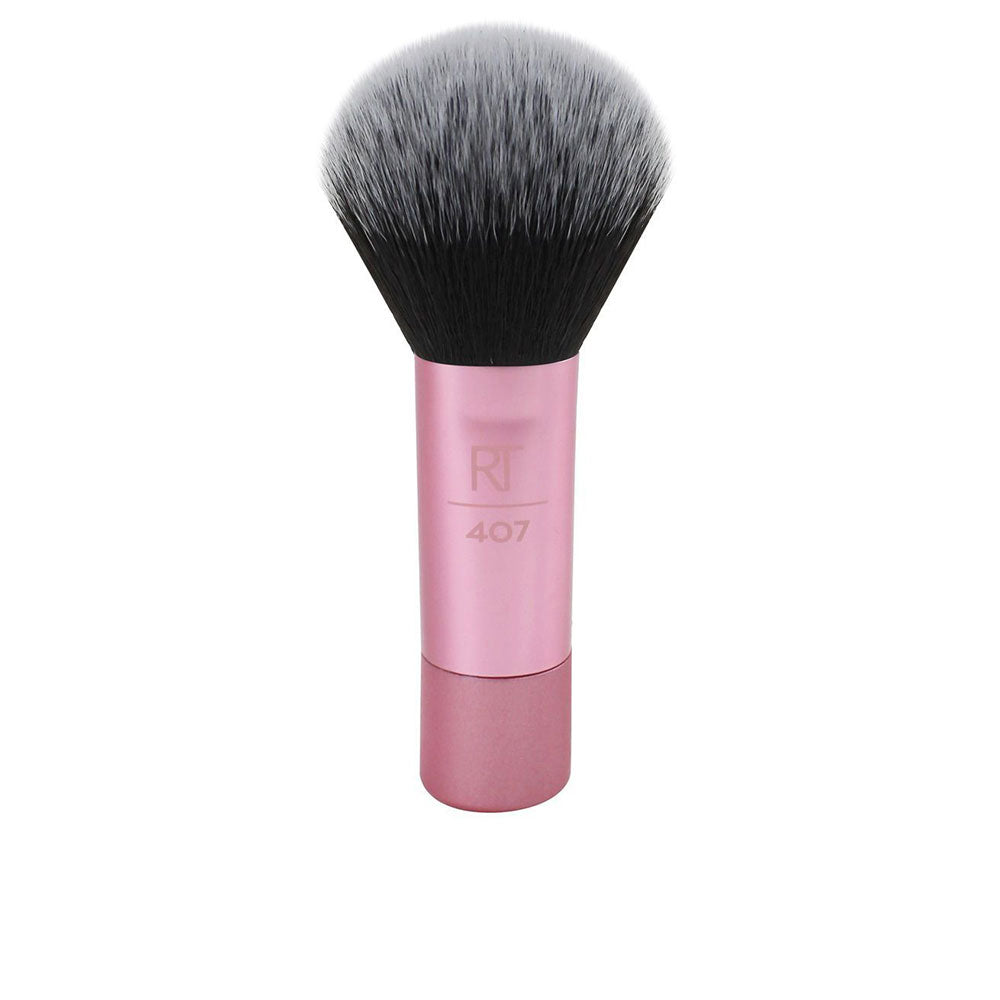 Compact synthetic makeup brush with short handle and rounded dense head